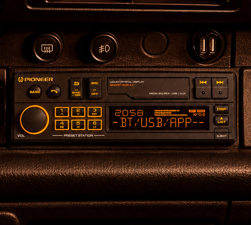 Pioneer car stereo headunit with a crystal display showing BT/USB/App, installed in a vehicle dashboard.