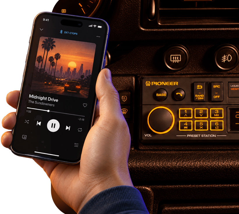 A hand holds a smartphone showing a music player app next to a car stereo console with a visible Pioneer logo, demonstrating wireless audio playback in a car interior.