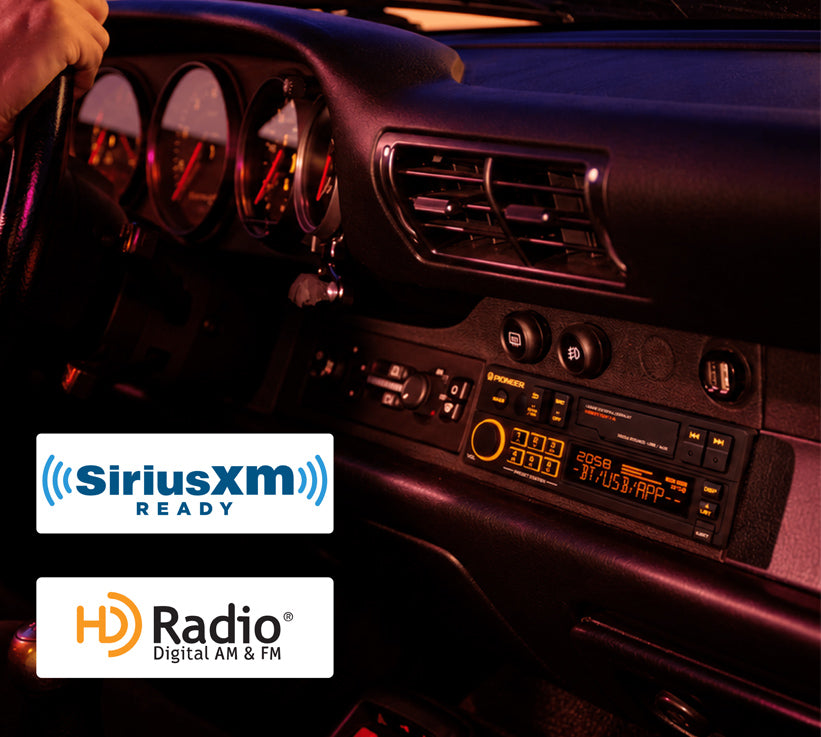 A car dashboard radio console in a dimly lit vehicle interior, with SiriusXM Ready and HD Radio Digital AM & FM logos overlaid at the bottom left.